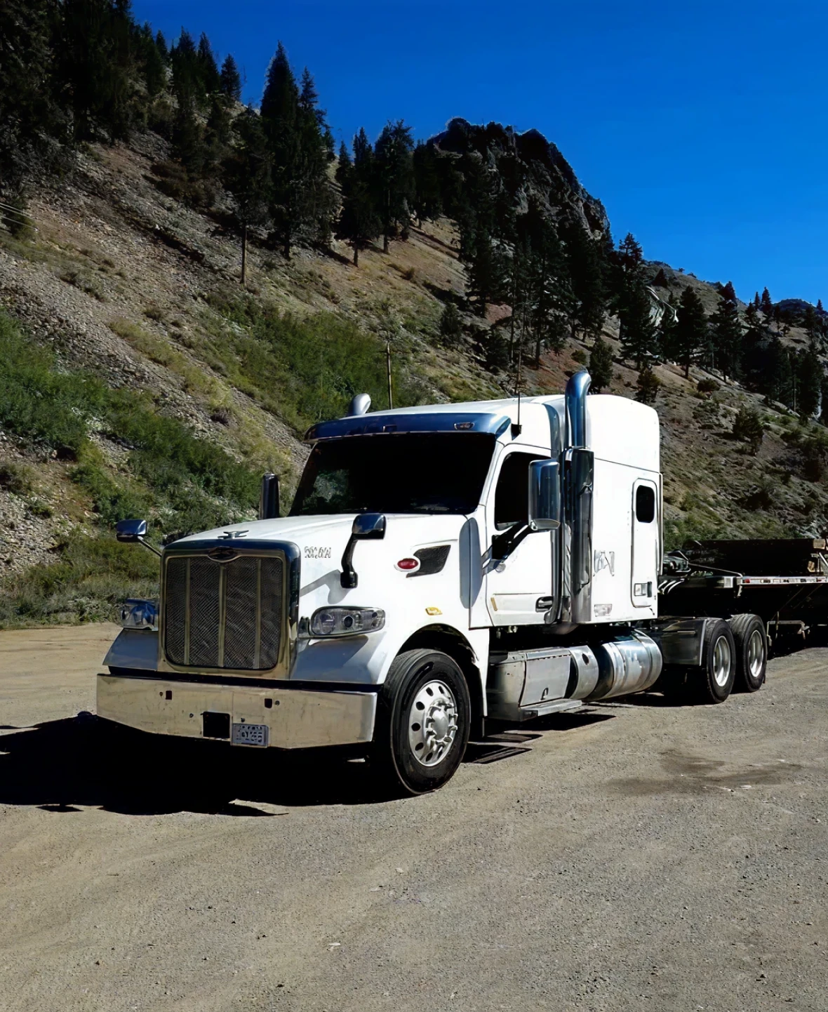 White semi-truck on mountain road